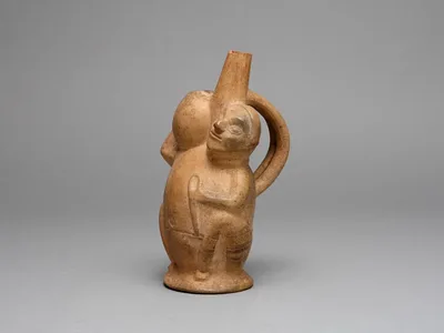 Handle Spout Vessel in the Form of a Seated Man Carrying a Jar by Lambayeque, 700–1000